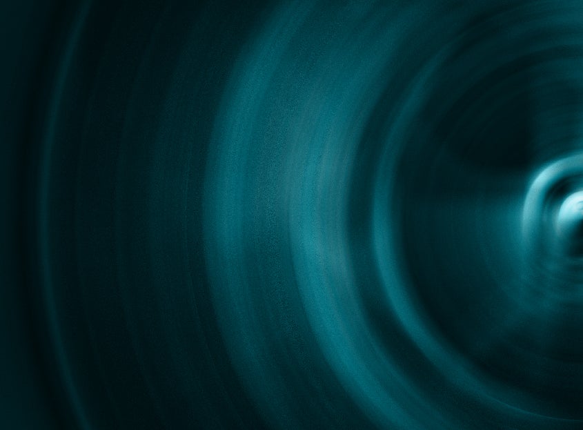Abstract blue circular light pattern with dark gradient background